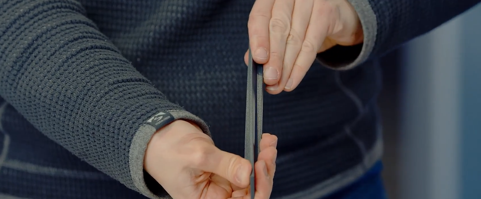 Man holding a 3D printed item to showcase the material.